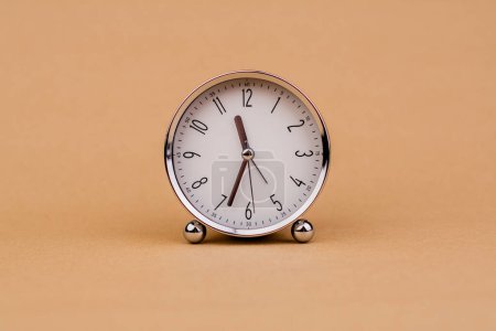 Photo for Alarm clock. Beautiful modern clock lies on paper background. time clock time standstill time off work working with time time concept - Royalty Free Image