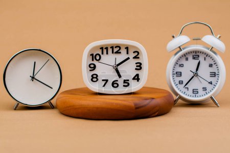 Photo for Alarm clock placed on a wooden stand, time work concept the value of limited time Appointments and punctuality at work - Royalty Free Image