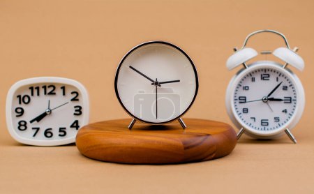 Photo for Alarm clock placed on a wooden stand, time work concept the value of limited time Appointments and punctuality at work - Royalty Free Image