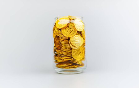Saving gold coins in a glass jar, savings concept, financial planning and investment Cash flow and income