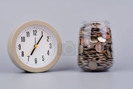 Money and time savings in a glass bottle, financial planning and investing in the stock market.