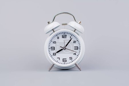 Modern alarm clock ticking, standing still time, time concept, time photography in studio.