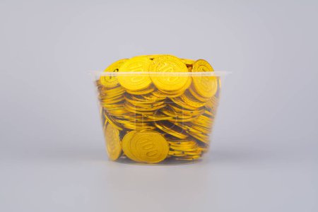Gold coins in glass jars, high exchange rate investment and gold stocks