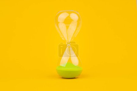 Photo for Hourglass on yellow background, time and countdown time limit for urgent work to meet deadlines and appointments. - Royalty Free Image