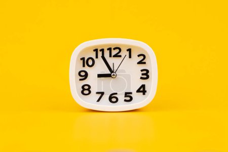 Photo for Clock on a yellow background, working with time and planning life, studio photo - Royalty Free Image