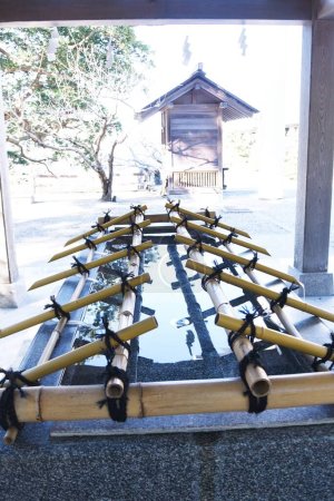 The purification fountain 'Chozuya' in the Japanese shrine. It's place where you wash your hands and rinseyour mouth at a shrine. This is a ritual cleansing.