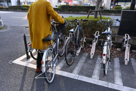Photo for Bicycles in the bicycle parking rack in Japan. If left on the sidewalk, it will disturb passers-by and damage the scenery, so it is necessary to observe manners. - Royalty Free Image