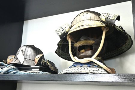 Photo for Japan tourism, Japanese history and culture. Old Japanese combat uniform 'Yoroi' and 'Kabuto'. Japanese Armor and Samurai Warrior helmet. - Royalty Free Image