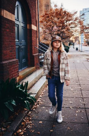 Foto de Portrait of stylish teenage boy walking in downtown. street fashion. urban style - Imagen libre de derechos