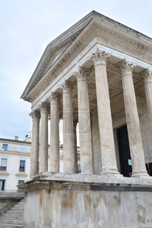 Photo for The prnoas of the Maison Carree in the centre of Nimes, Southern France. This is a 2,000 year old Ancient Roman Temple the best preserved of its kind anywhere - Royalty Free Image