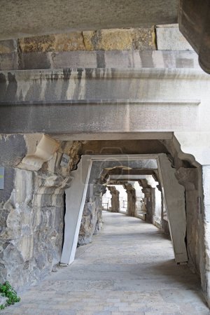 Photo for Internal corridor of an Ancient Roman Amphitheatre at Nimes in the South of France with steps leading to the seats and the exits. One of the best preserved amphitheaters in the world - Royalty Free Image