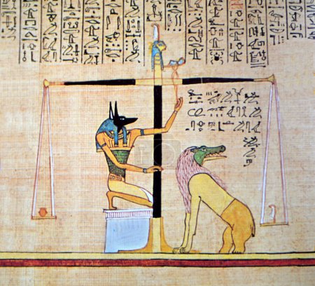 Photo for Ancient Egyptian papyrus of Anubis weighing the heart against the feather of Maat. If guilty of a number of crimes, the deceased's soul will be eaten by the waiting monster Ammit - Royalty Free Image