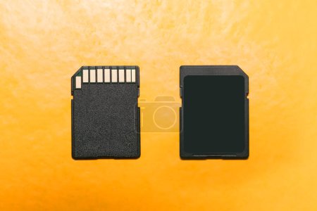 black sd card front and back isolated on yellow background