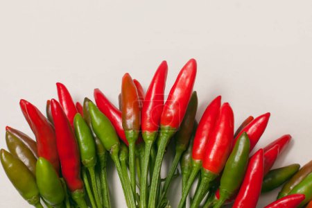 many small chili peppers on white background
