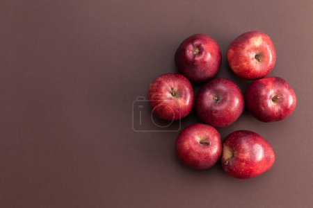 Photo for Many red apples isolated on brown background - Royalty Free Image