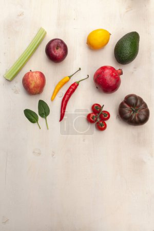 Photo for Fruits and vegetables on white wooden background - Royalty Free Image