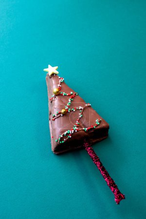 Photo for Christmas tree shaped chocolate cakes on stick - Royalty Free Image
