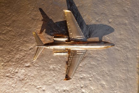 Téléchargez les photos : Avion jouet doré sur fond doré - en image libre de droit