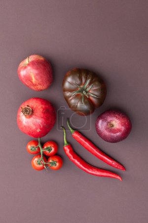 Photo for Red fruits and vegetables on brown background - Royalty Free Image