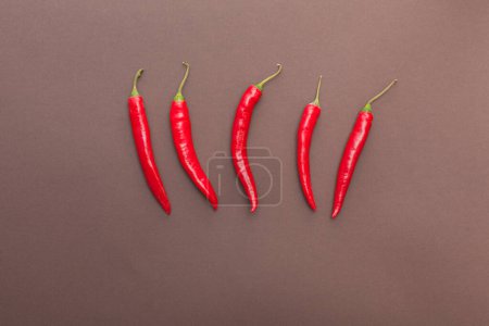 red hot chili peppers on brown background