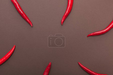 red hot chili peppers on brown background