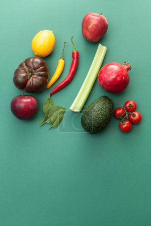 fruits and vegetables on green background