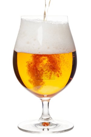 Foto de Lager of pilsner beer is pouring into snifter glass isolated on a white background - Imagen libre de derechos