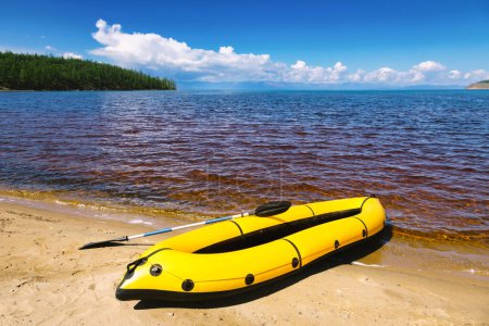 Photo for Yellow packraft, portable inflatable rubber boat with padle on Khovsgol Lake shore in northern Mongolia - Royalty Free Image