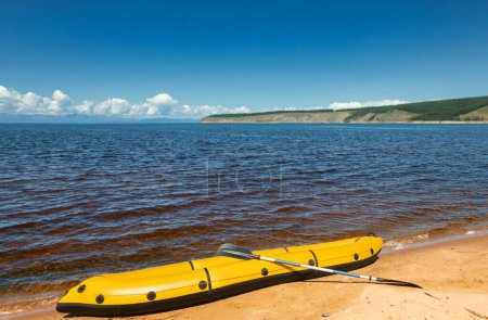 Photo for Yellow packraft, portable inflatable rubber boat with padle on Khovsgol Lake shore in northern Mongolia - Royalty Free Image