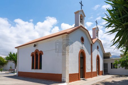 Photo for The front of a small beautiful red and white colored church (Ekklisia Sotiros Christos Monastiri) in Rethymno, Crete, Greece - Royalty Free Image