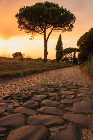 sunset on ancient roman road of appian way