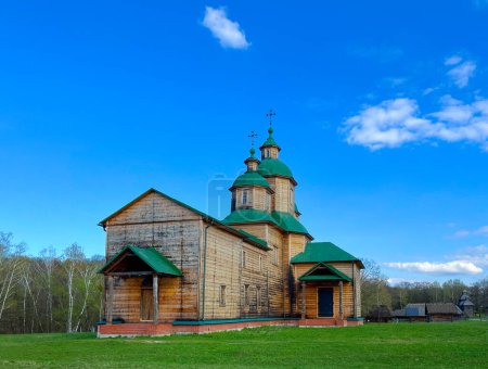 Majestic Wooden Church in Serene Pastoral Setting