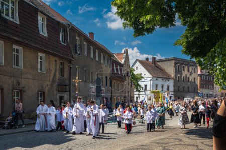 Photo for Zabkowice Slaskie, Poland  06.08.2023 The Feast of Corpus Christi, solemn procession, parishioners participating in the procession Ziebicka Street in Zabkowice Sl. - Royalty Free Image