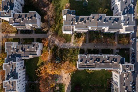 Photo for Aerial view of apartment buildings. Top down view of few apartment buildings, Pavement, trees and grass and trees. Typical old polish estate, Opole, autumn. - Royalty Free Image