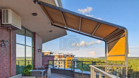 Awning on the terrace. Penthouse on the top floor with a terrace and a gorgeous view of the forest.