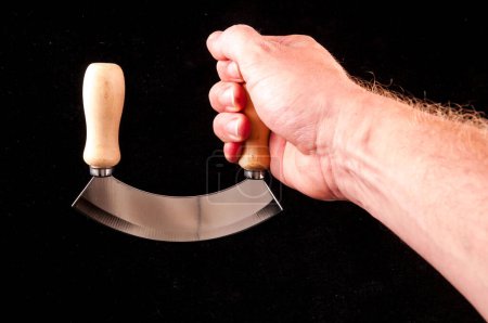 Photo Picture of a Kitchen Curved Metallic Knife Tool in hand 
