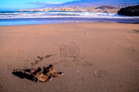 boots on Dry Lava Coast Beach in the Atlantic Ocean