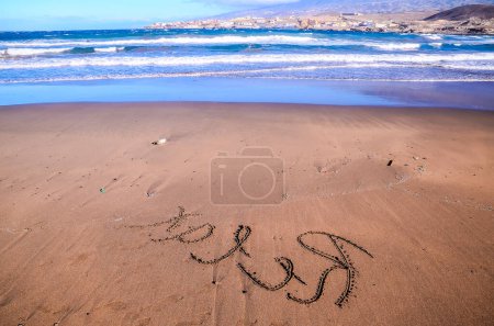 Word Written on the Sand of a Tropical beach