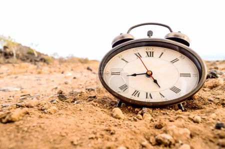 Classic Analog Clock In The Sand On The Rock Desert