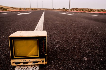 A Broken Gray Television Abandoned on the Road