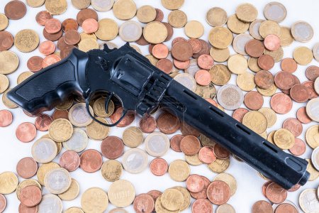 Imagen de un concepto de dinero de negocios Idea Monedas y pistola