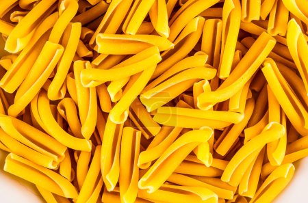 A pile of yellow pasta. The pasta is long and thin