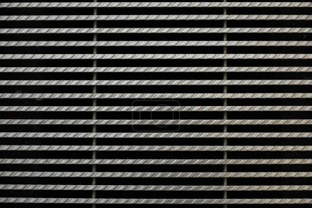 Background material photo showing a close-up of iron grating from above