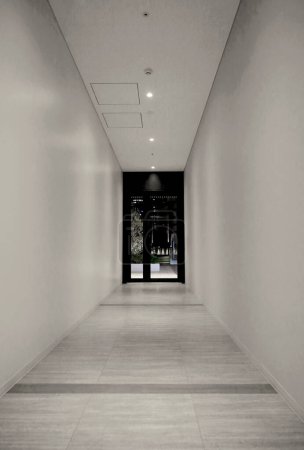 A midnight door at the end of an empty hallway that leads to the city inside the building
