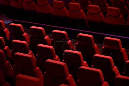 Red seats lined up in the theater