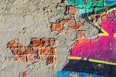 Photo for Abstraction from the destroyed brick wall of the city street with graffiti details. - Royalty Free Image