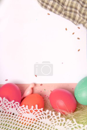 Foto de White empty paper list, Easter background with bright colored eggs - Imagen libre de derechos