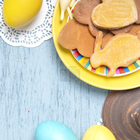 Photo for Easter table with colored eggs and holiday homemade cookies - Royalty Free Image