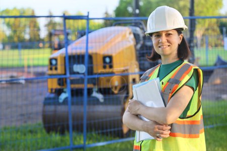 Photo for Outdoor builder woman portrait, construction woman worker, smiling and looking at camera - Royalty Free Image