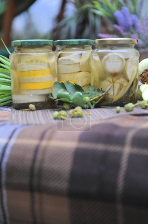 Photo for Home preservation with marinated zucchini, outdoor summer photo - Royalty Free Image